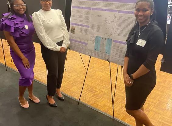 students present at science symposium with Dr. Chakia McClendon